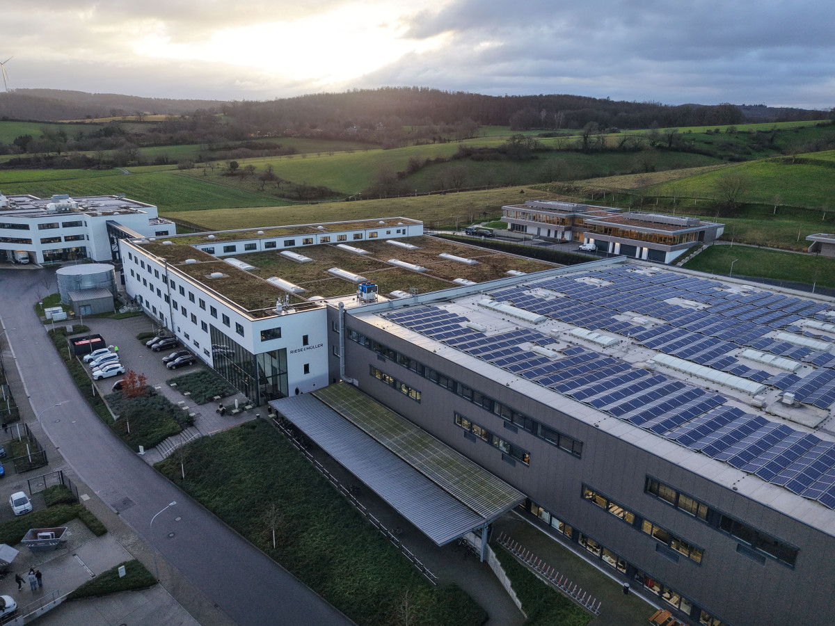 Picture shows factory with solar panels installed on the roof